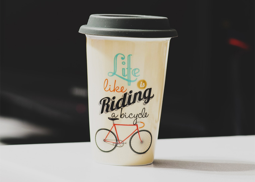 rinted paper coffee cup featuring a bicycle image
